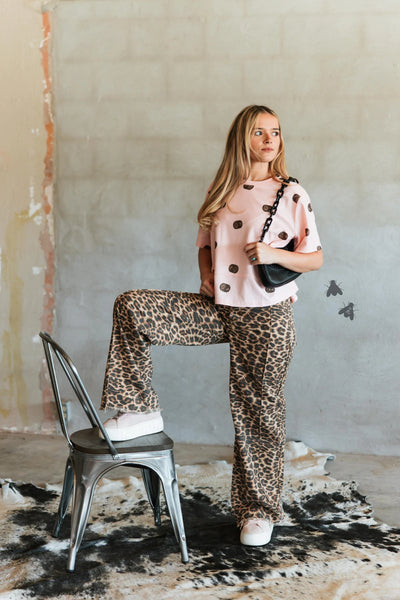 Women's leopard print wide leg jeans with raw hem and center seam