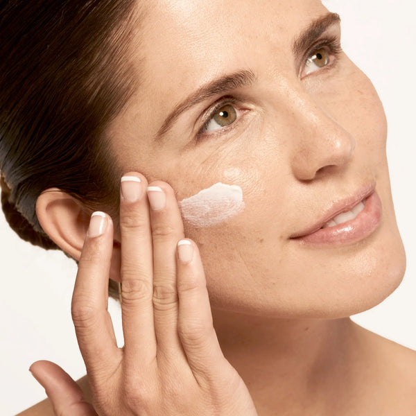 Model applying Microbiome Defense Daytime Moisturizer SPF 15.